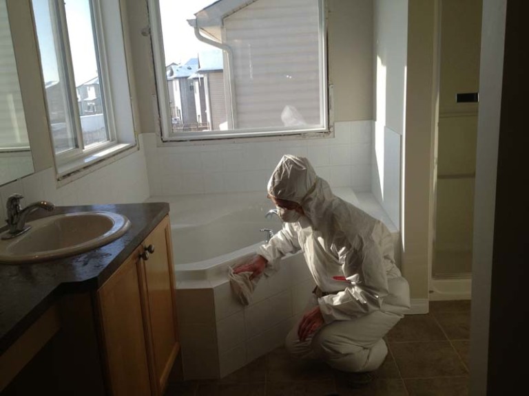 Worker cleaning construction dust during restoration cleanup