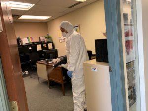 mayken hazmat solutions specialist using disinfectant spray in an office space